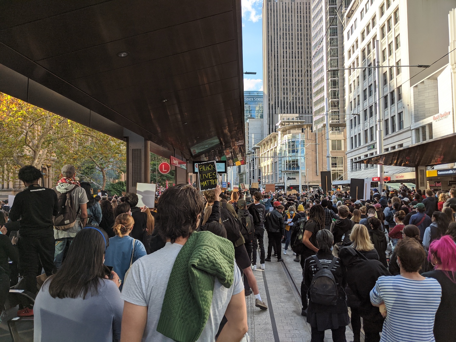 Protesters at Town Hall tram stop listening to speeches